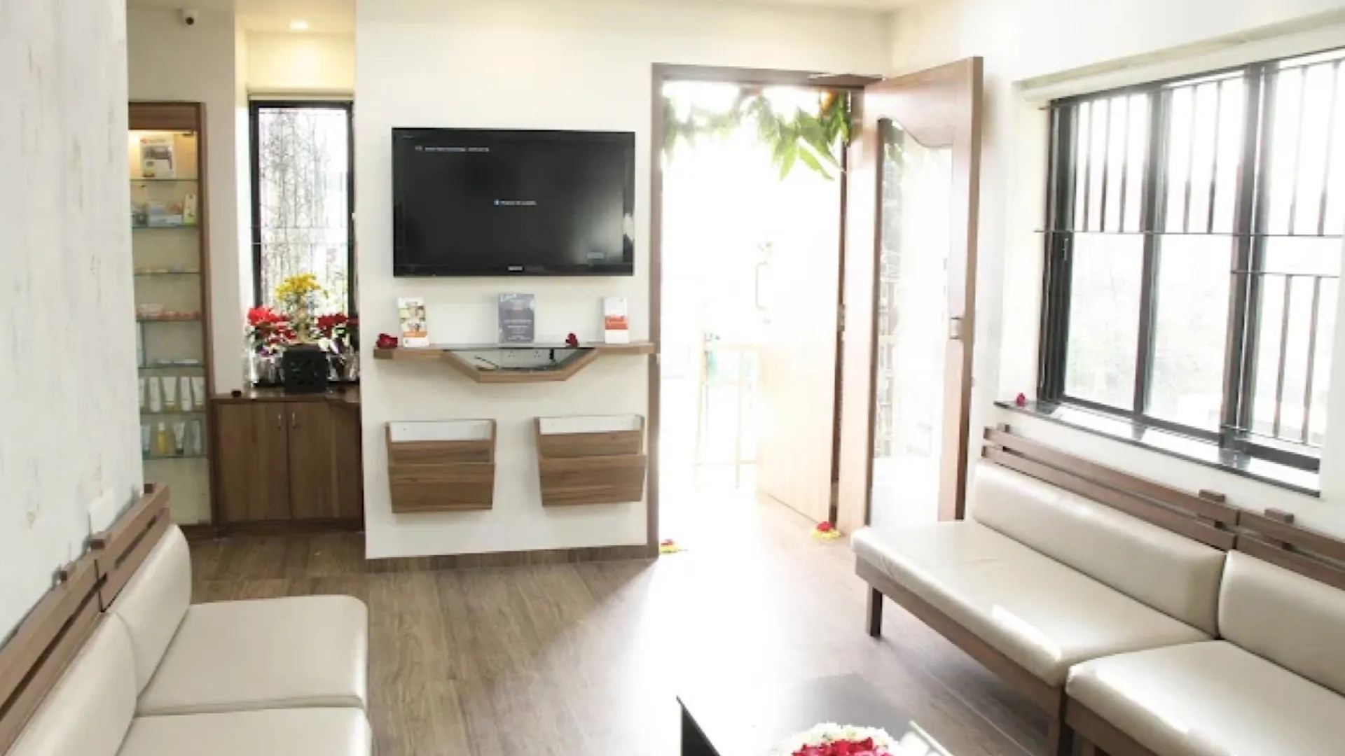 The patient lounge at Nital Aesthetics in Akota — daylight, plants and unhurried seating